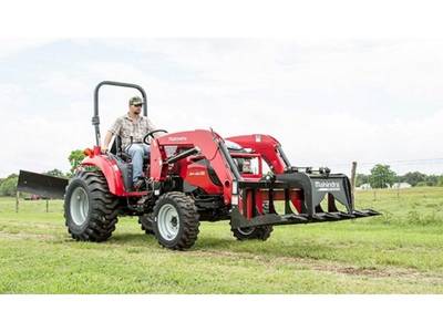 Man driving a 2019 Mahindra 1533 HST across a grass field